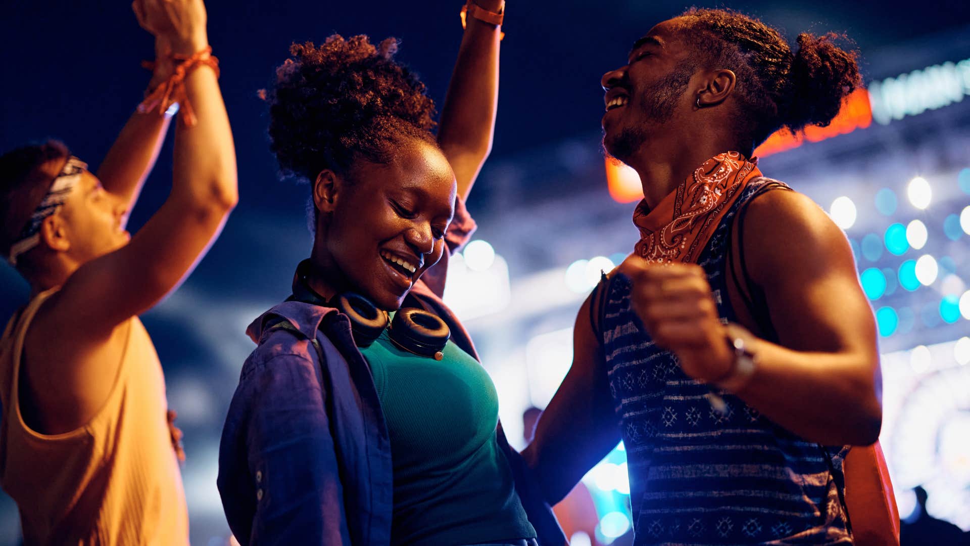 Couple smiling and dancing at a concert