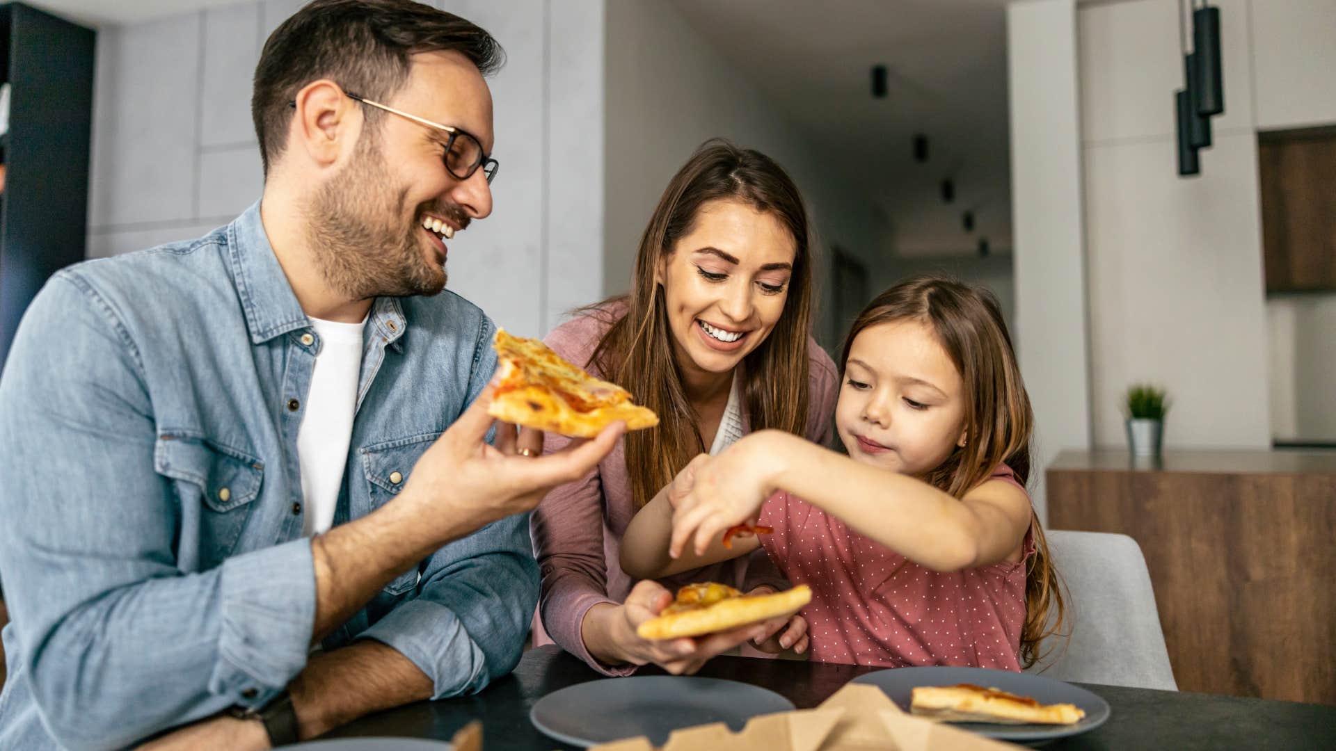 Family eating fast food together at a table