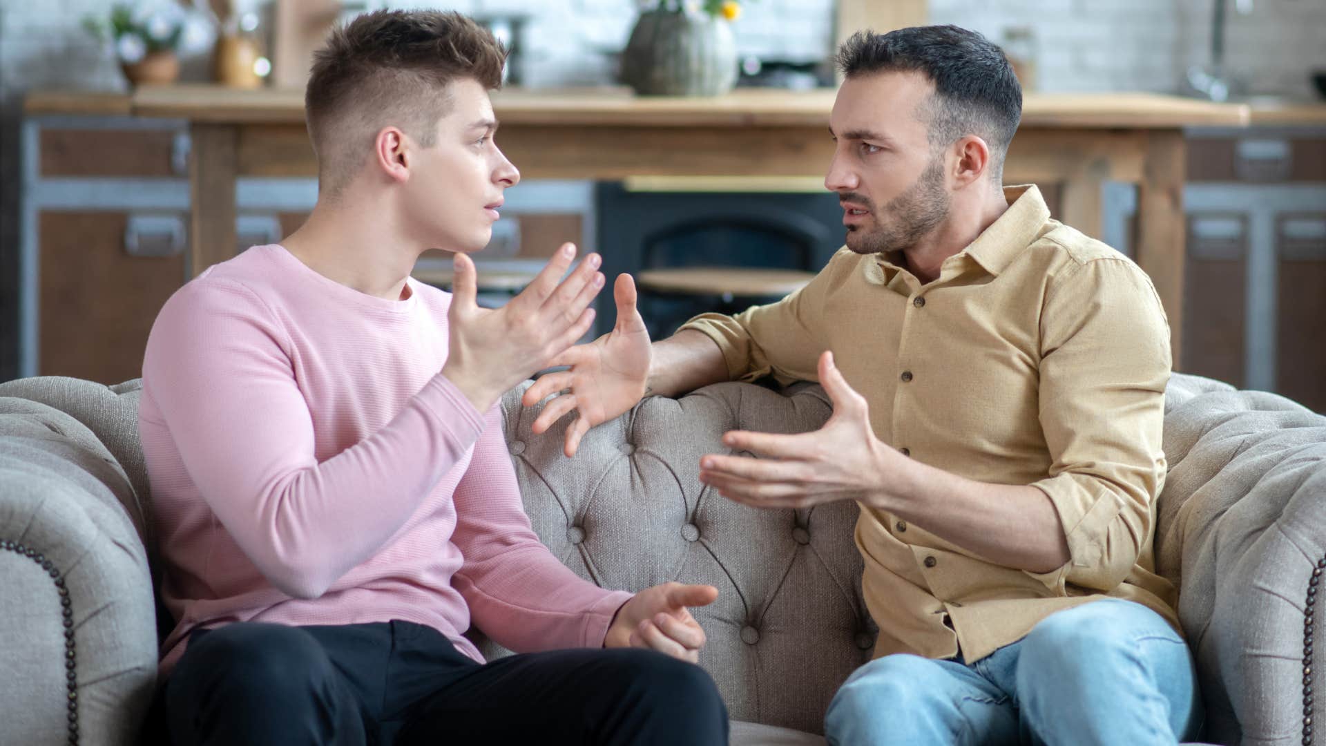 Couple arguing on the couch.