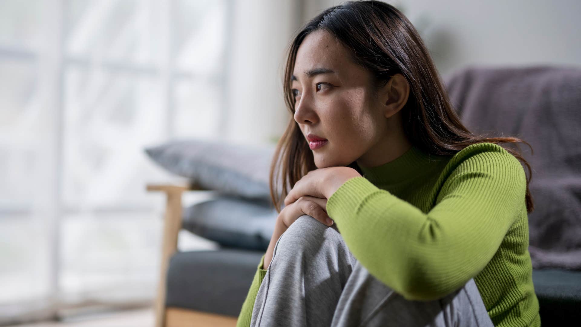 Sad woman sitting on the ground.