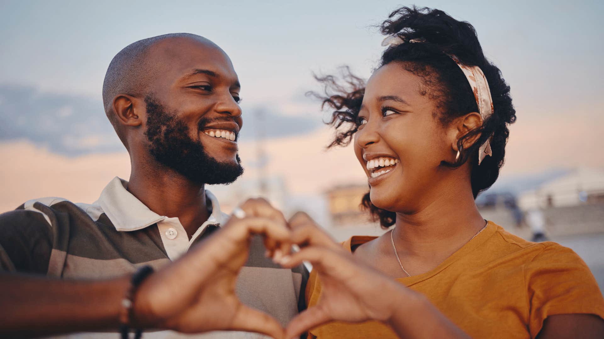 couple making a heart with their hands