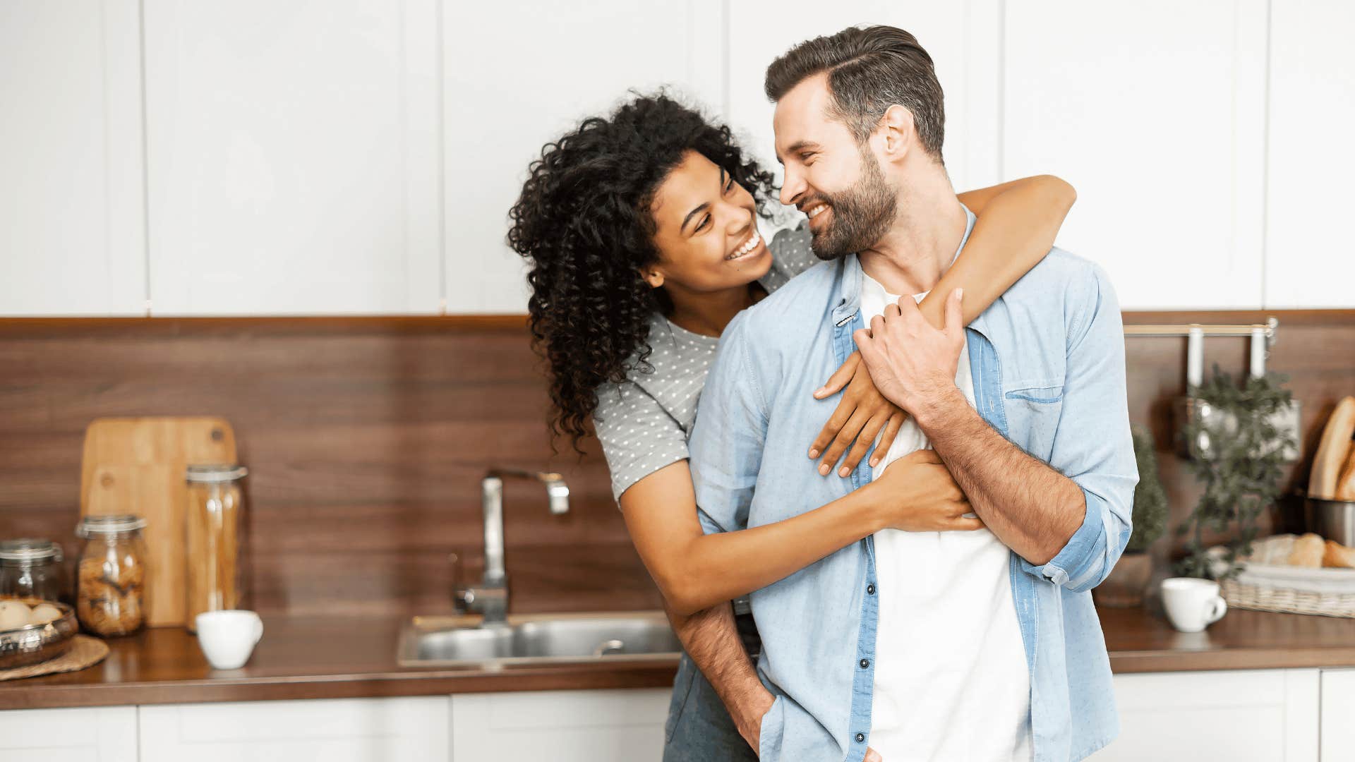 couple embracing in kitchen