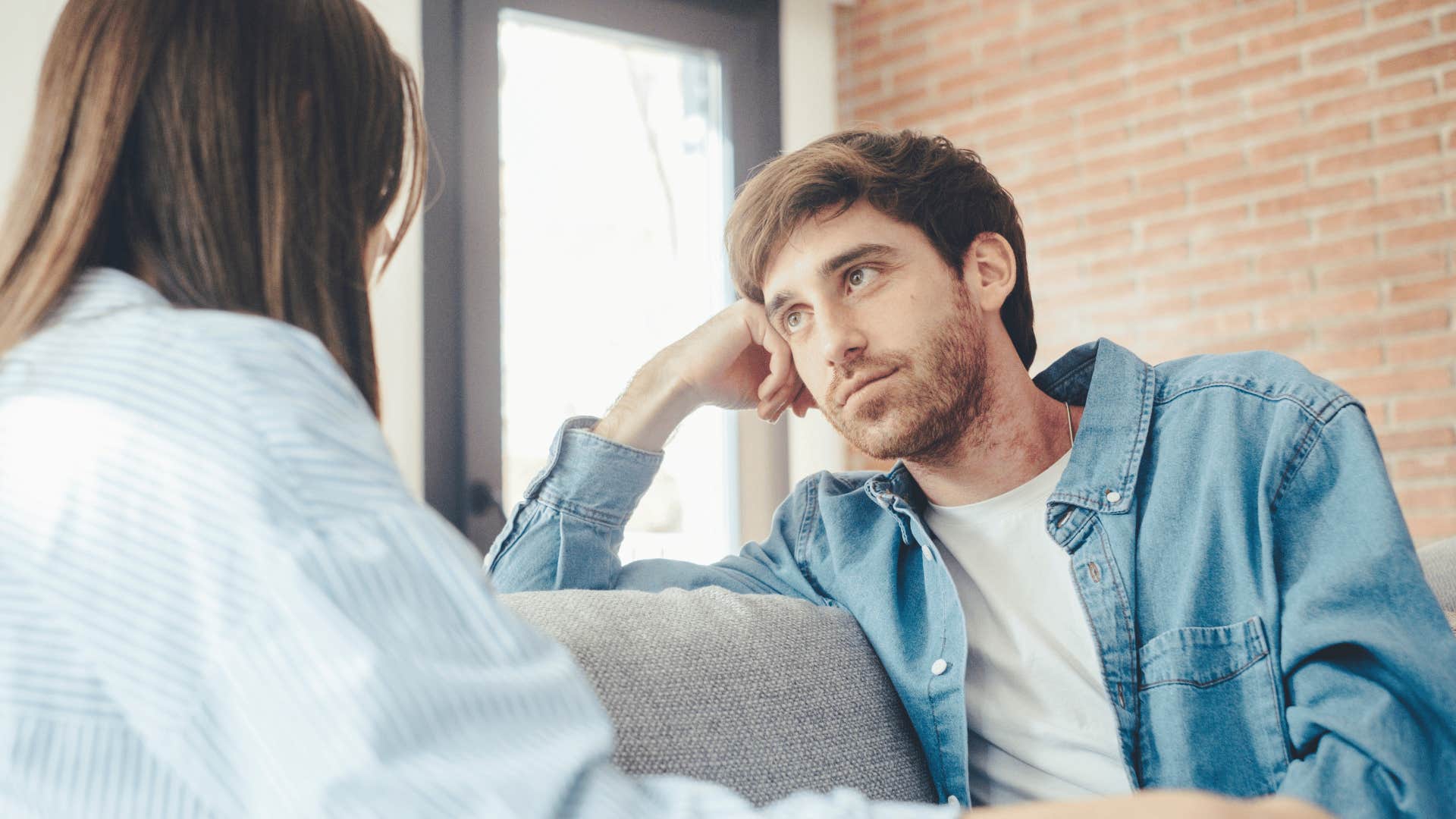 couple sitting on couch talking