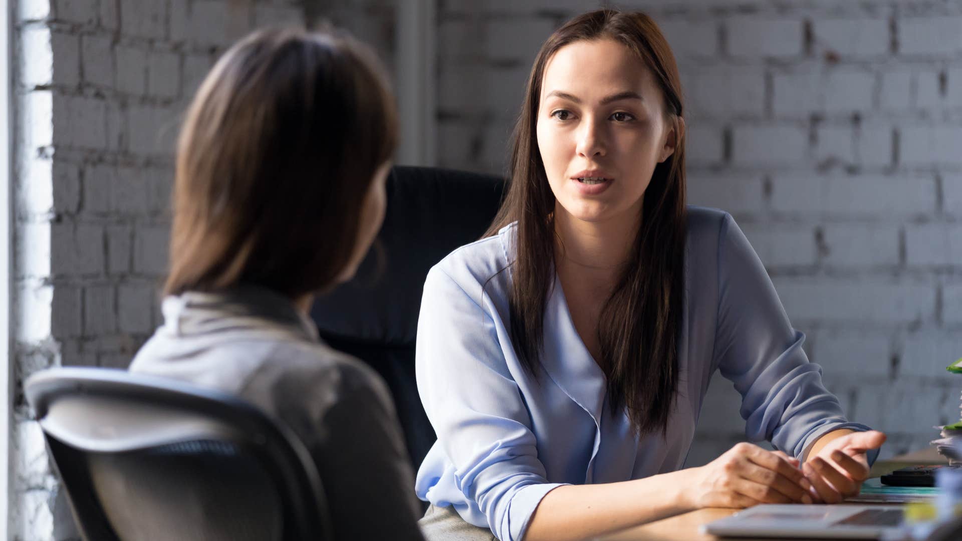 Woman talking to her boss at work