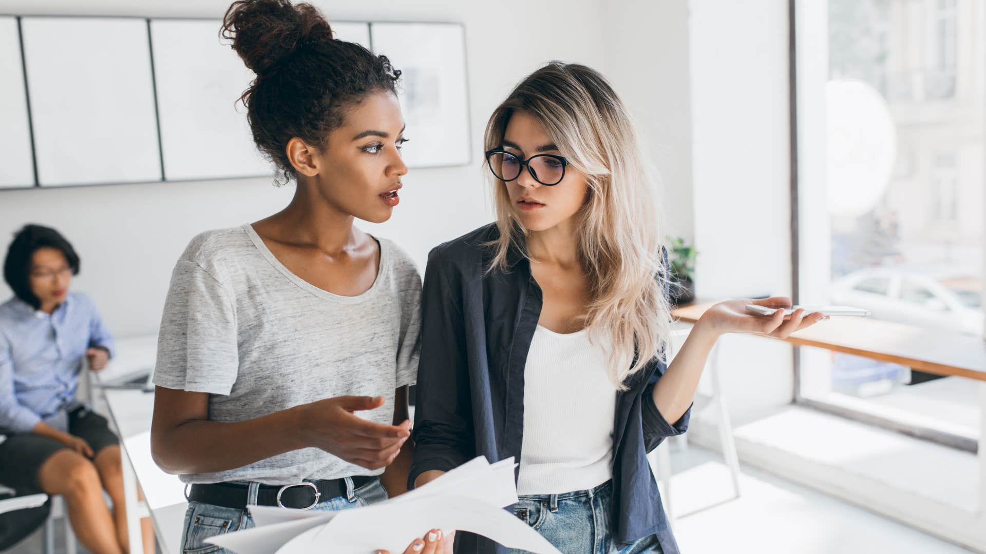 Two professional women talking in an office