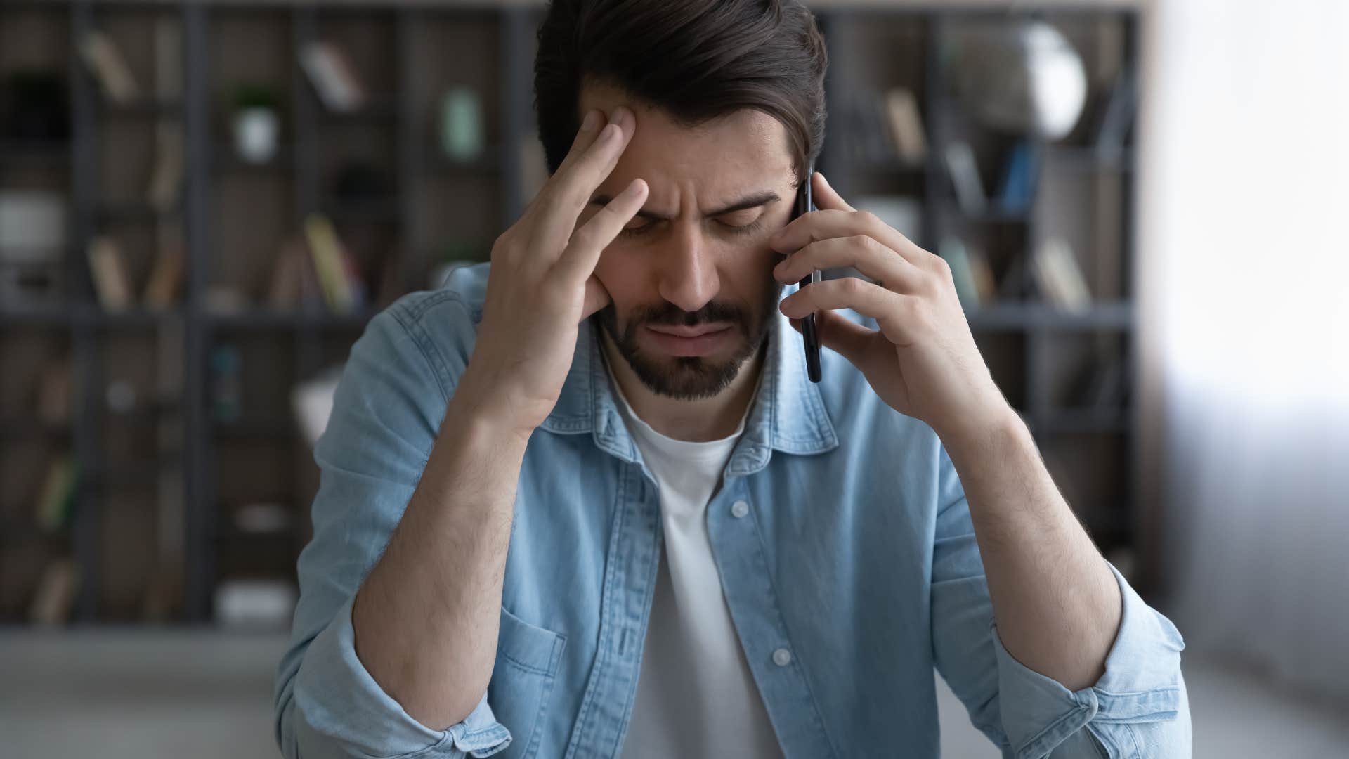 Man looking annoyed while talking on the phone