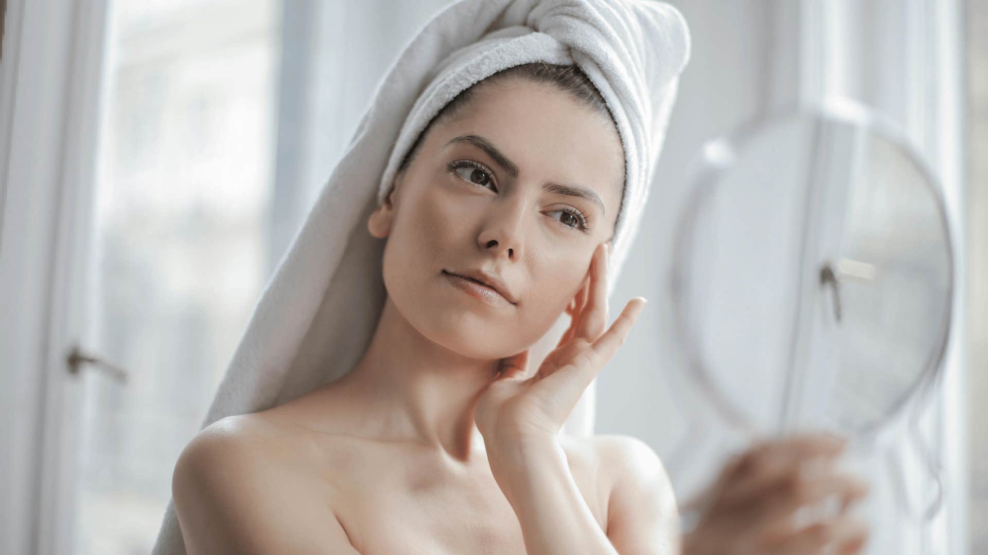 woman looking in mirror