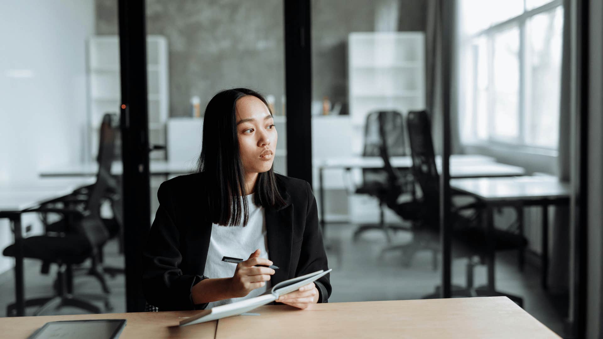 woman taking notes in office