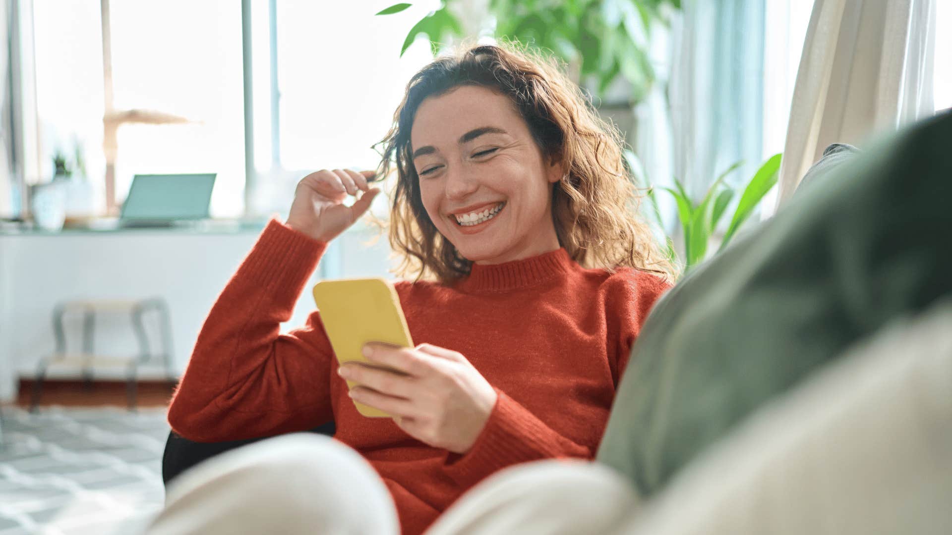 woman smiling looking at phone