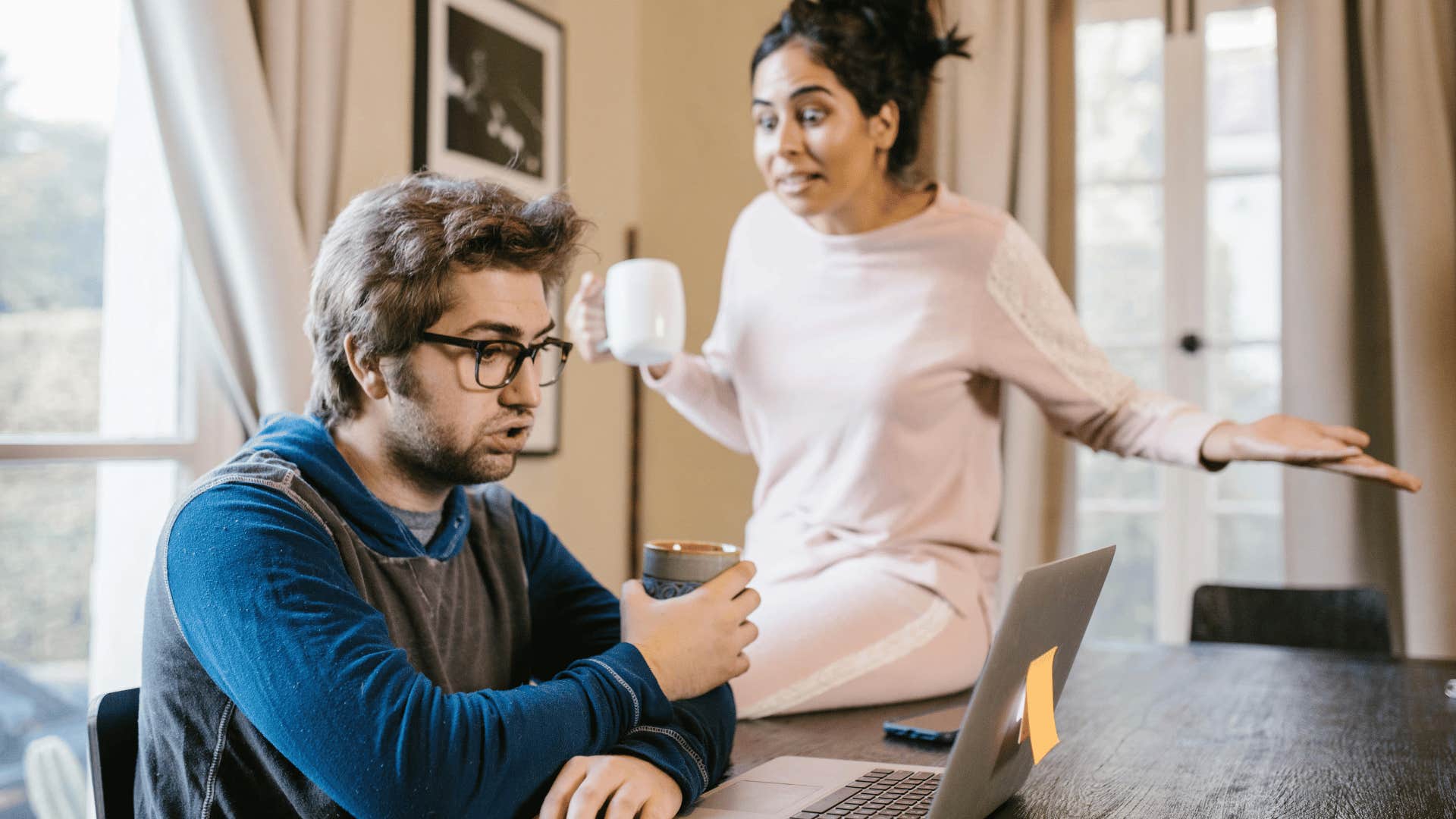 woman yelling at man on laptop