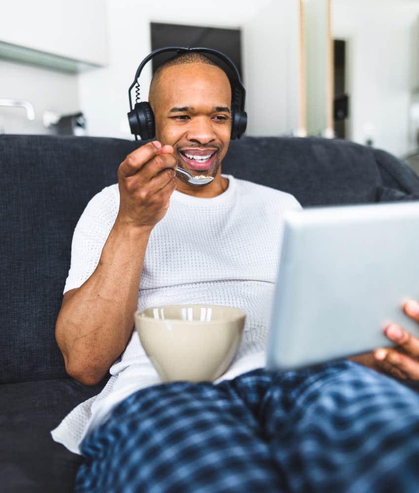 man eating on couch 