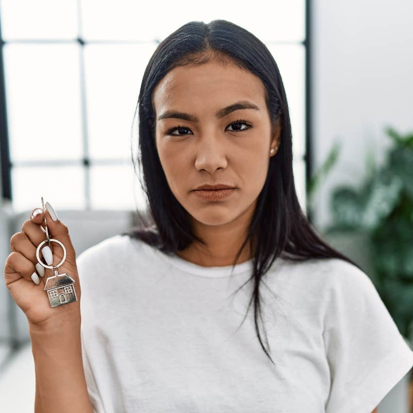 Sad woman holding new house key