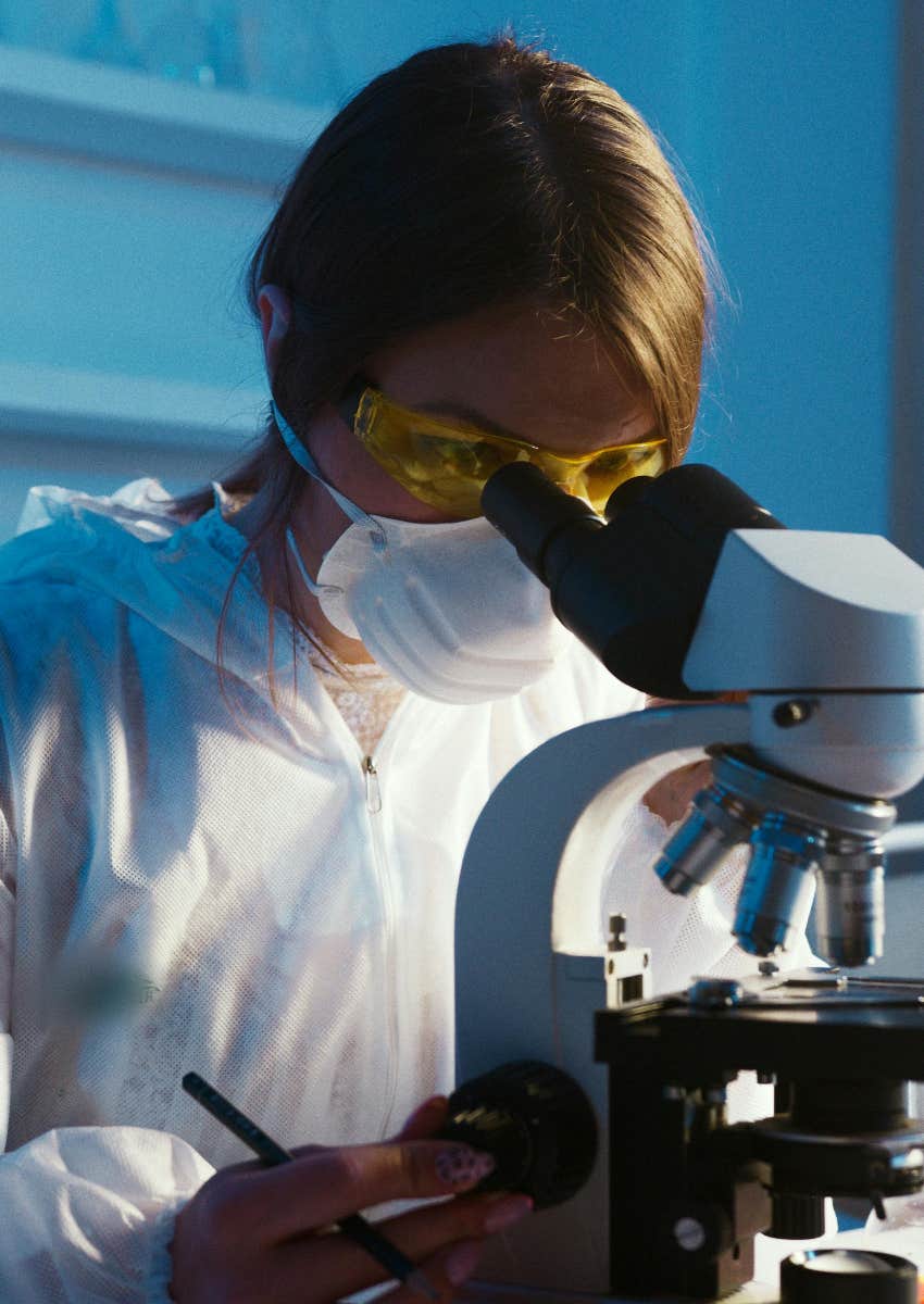 scientist looking in microscope