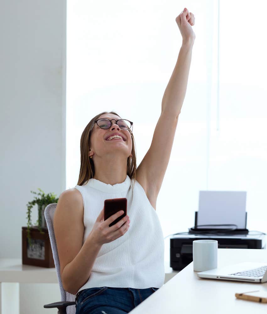 woman celebrating with her hand in the air