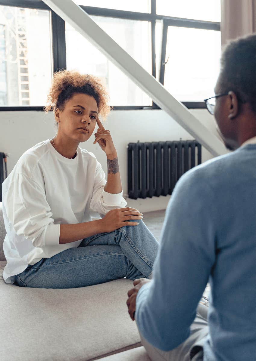 serious woman staring at man