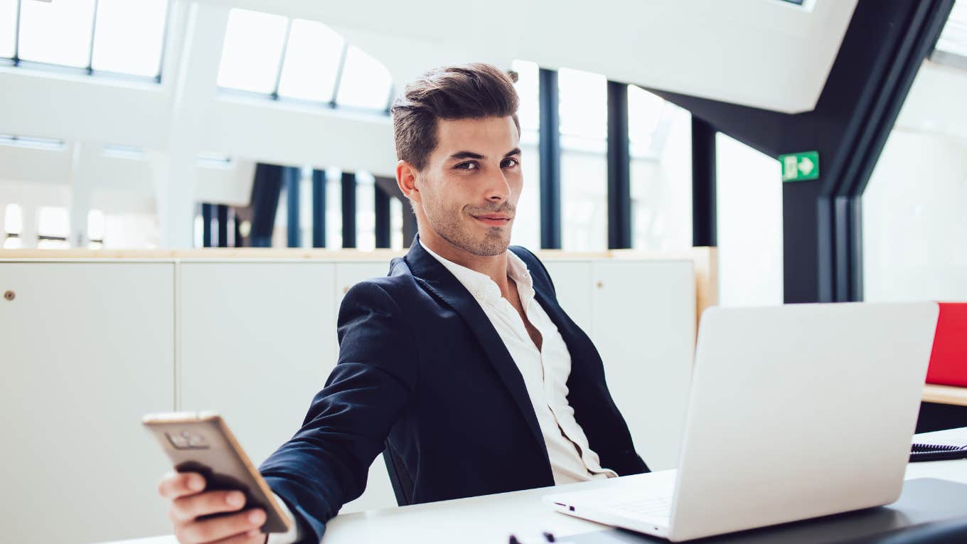 Corporate pick-me employee smirking at desk