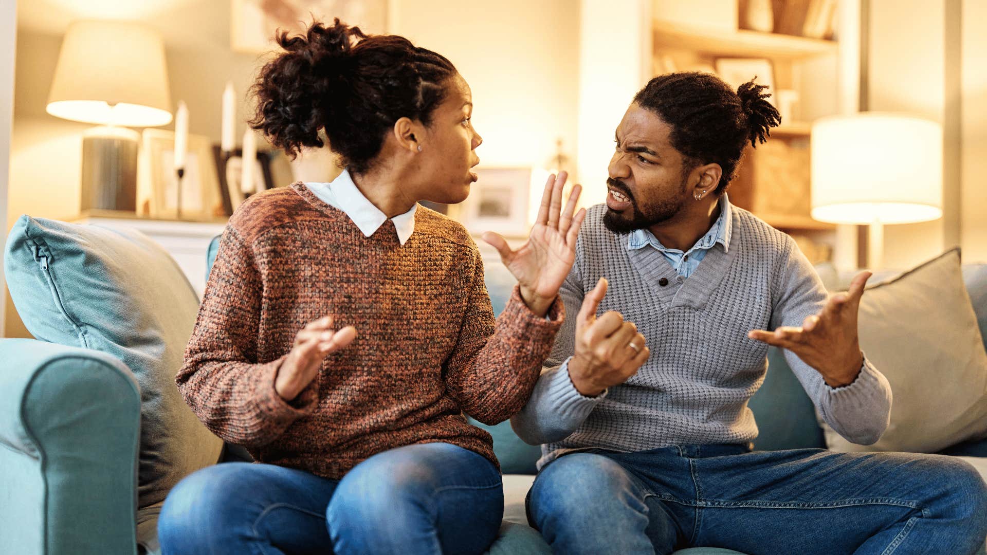 man and woman arguing on couch