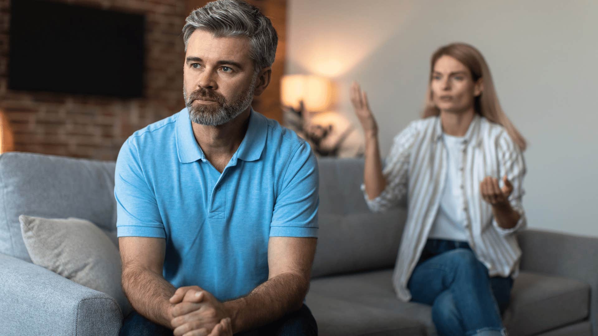 woman trying to talk to man while man ignores her