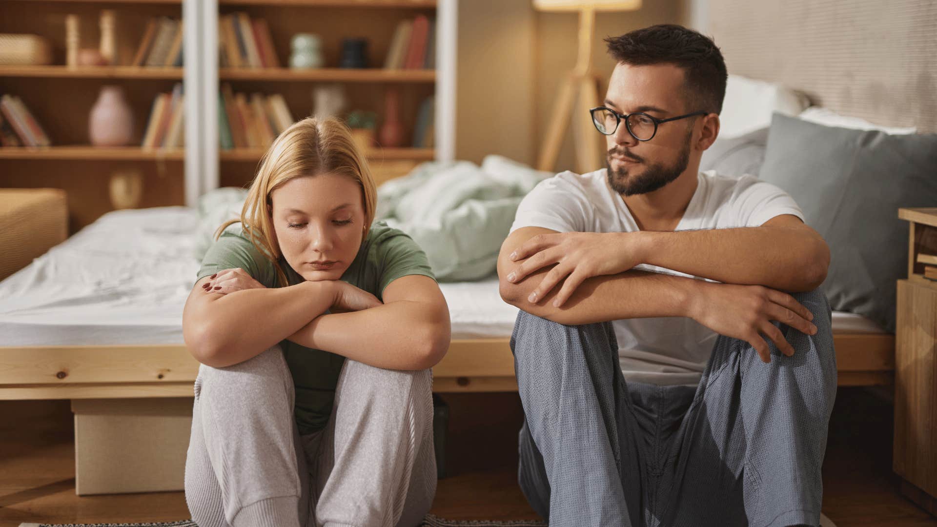 man looking at upset woman not knowing what to do