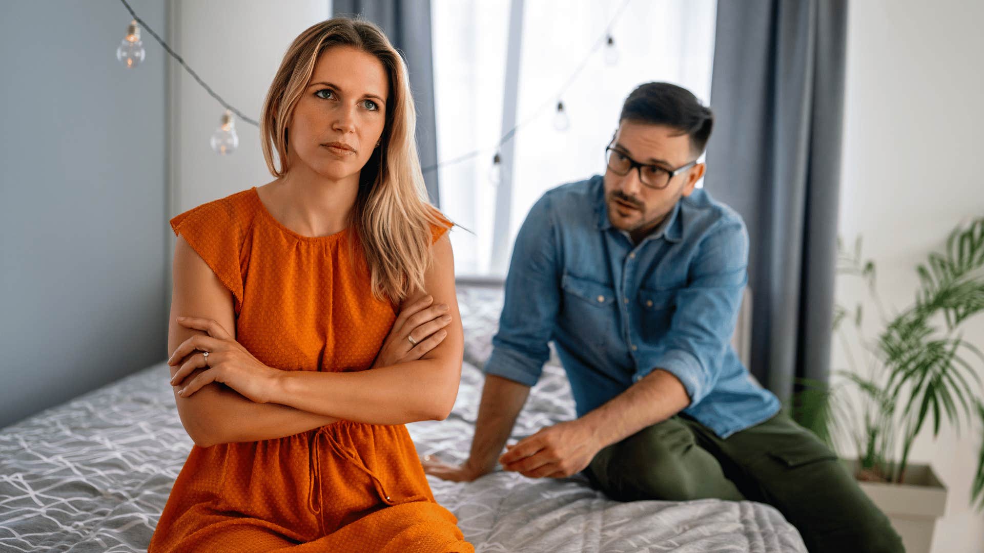 woman crossing arms and ignoring man