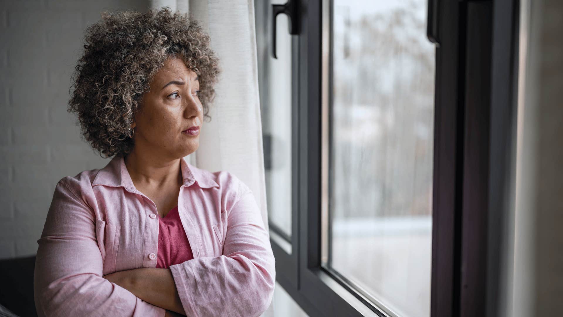 older woman looking out window