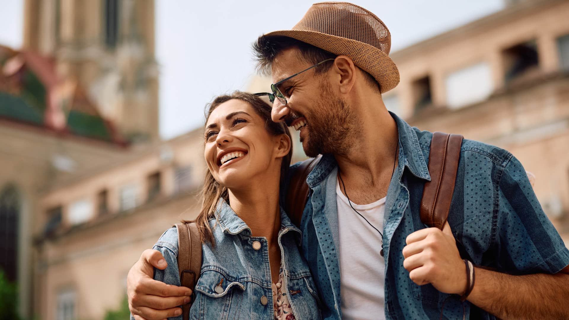 Couple smiling and walking around outside.