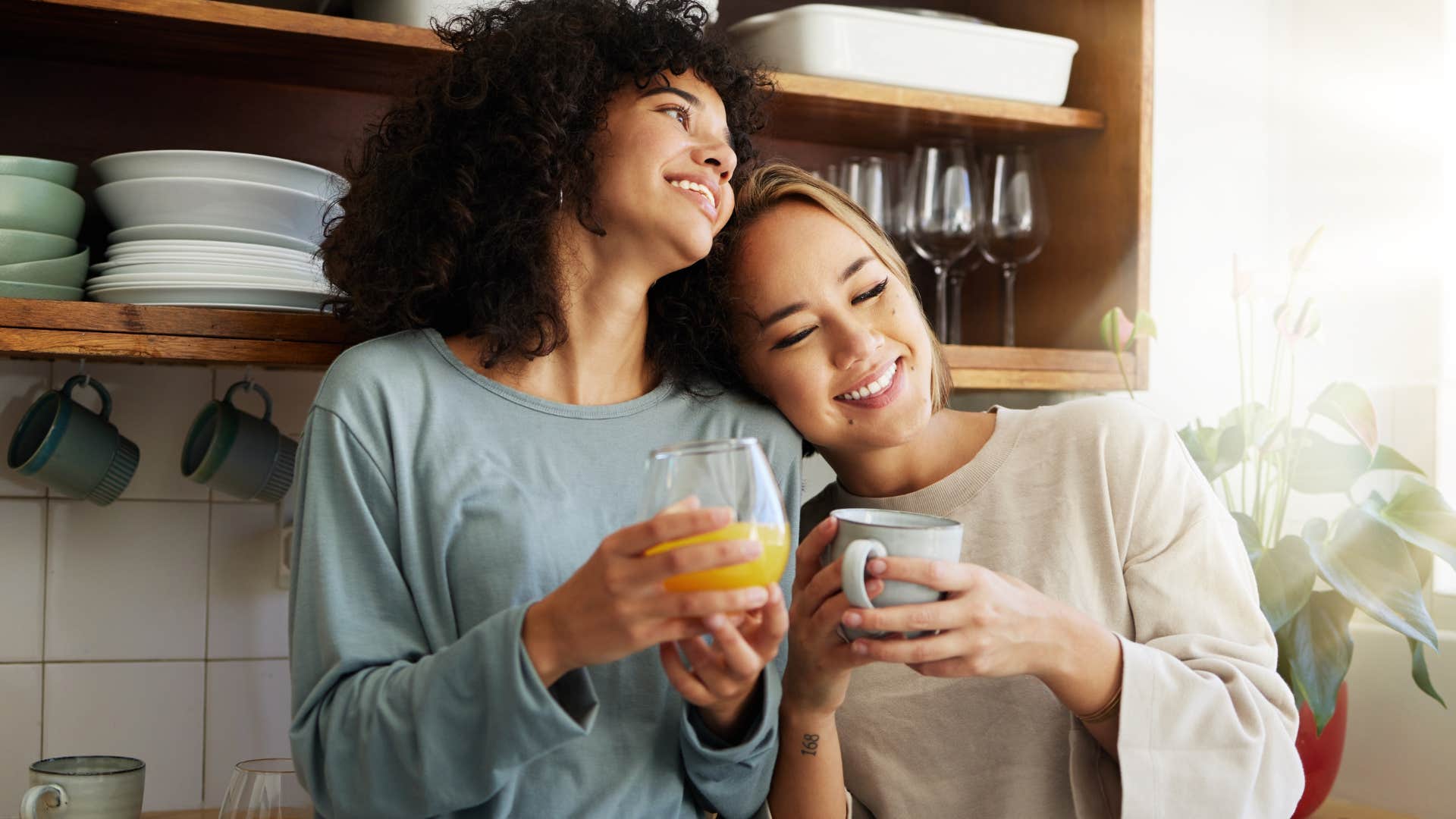 Couple smiling and drinking coffee together.