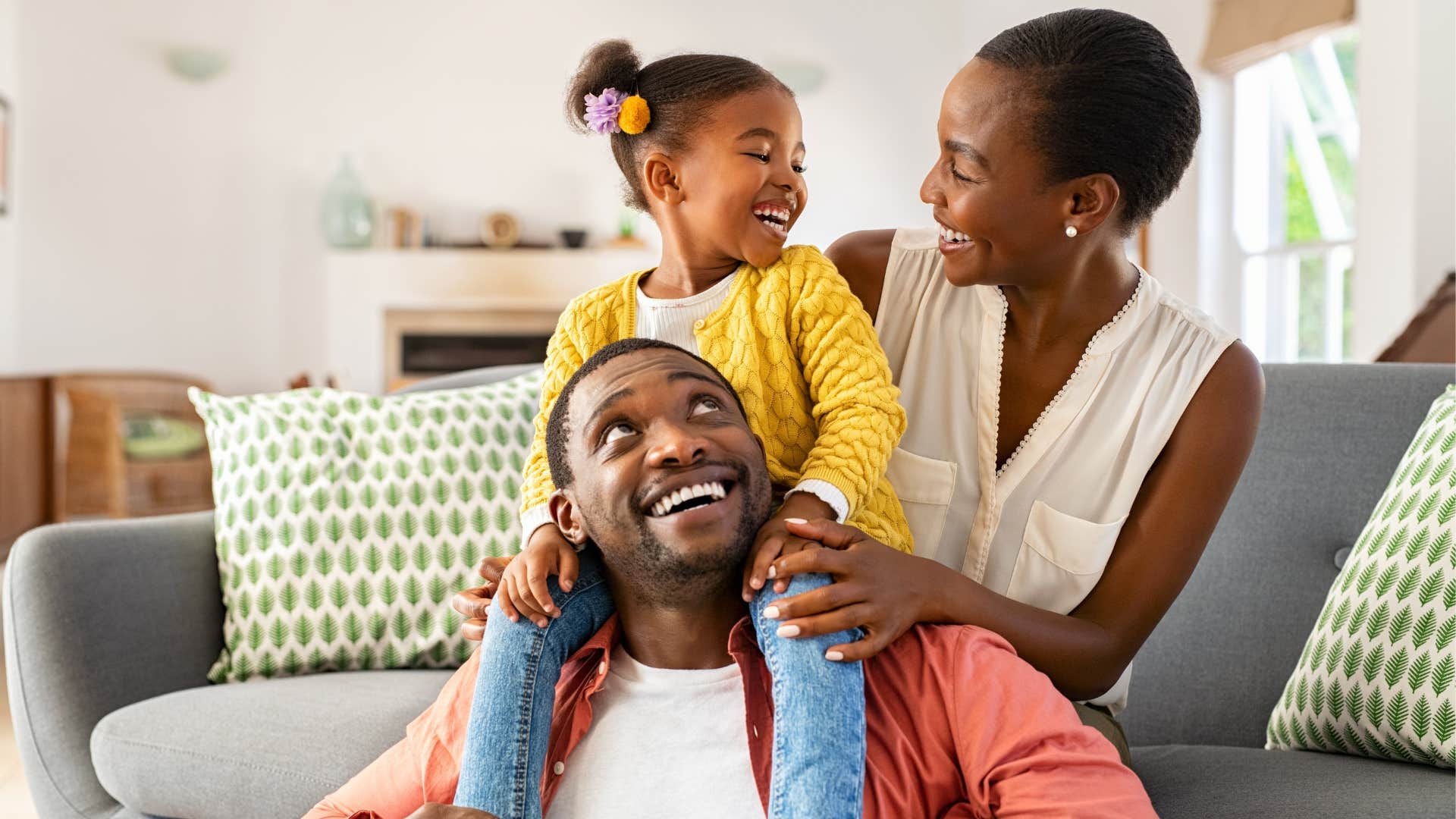 Happy family smiling in their living room together.