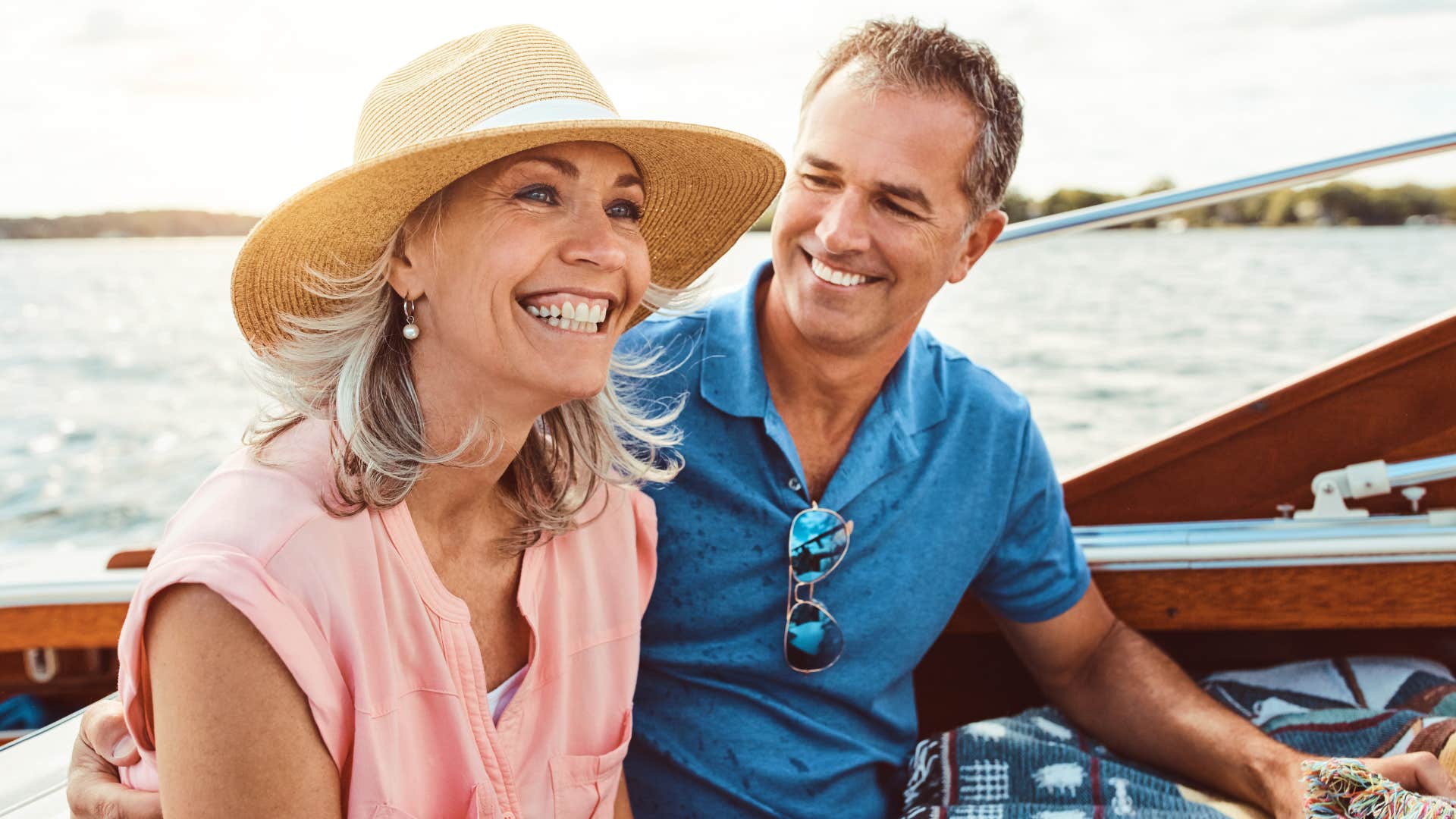 Couple smiling on a boat together.