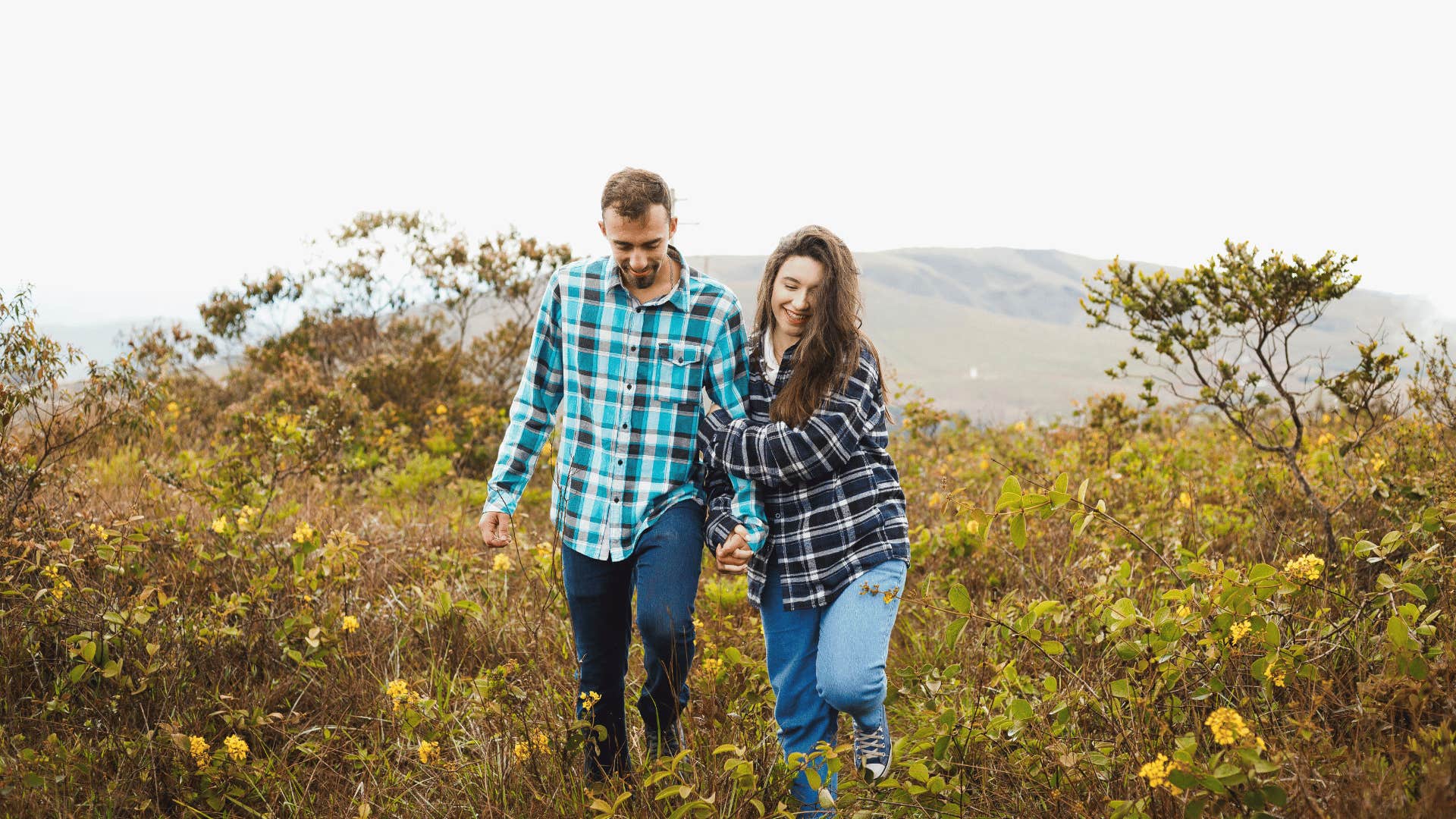 couple holding hands and walking