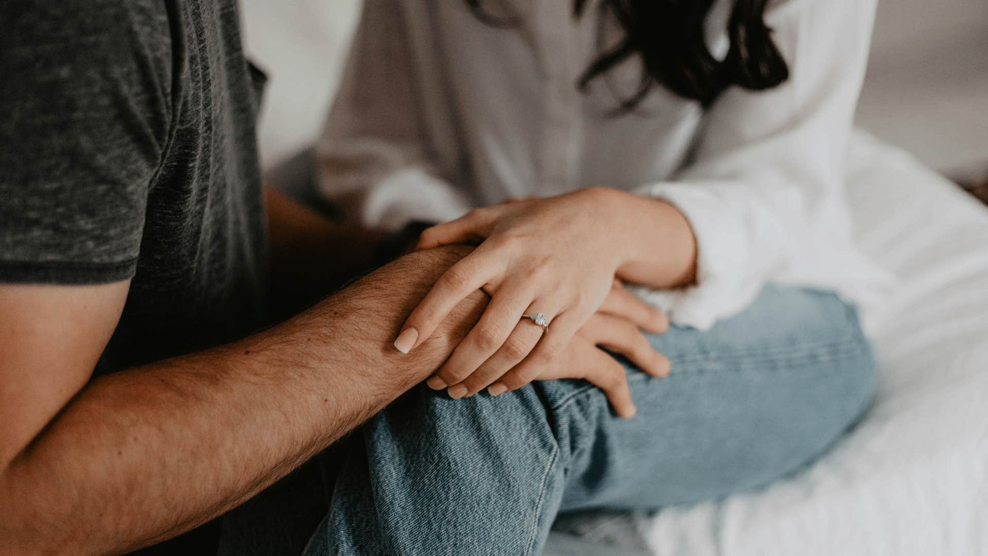 couple with their hands on each other's knees