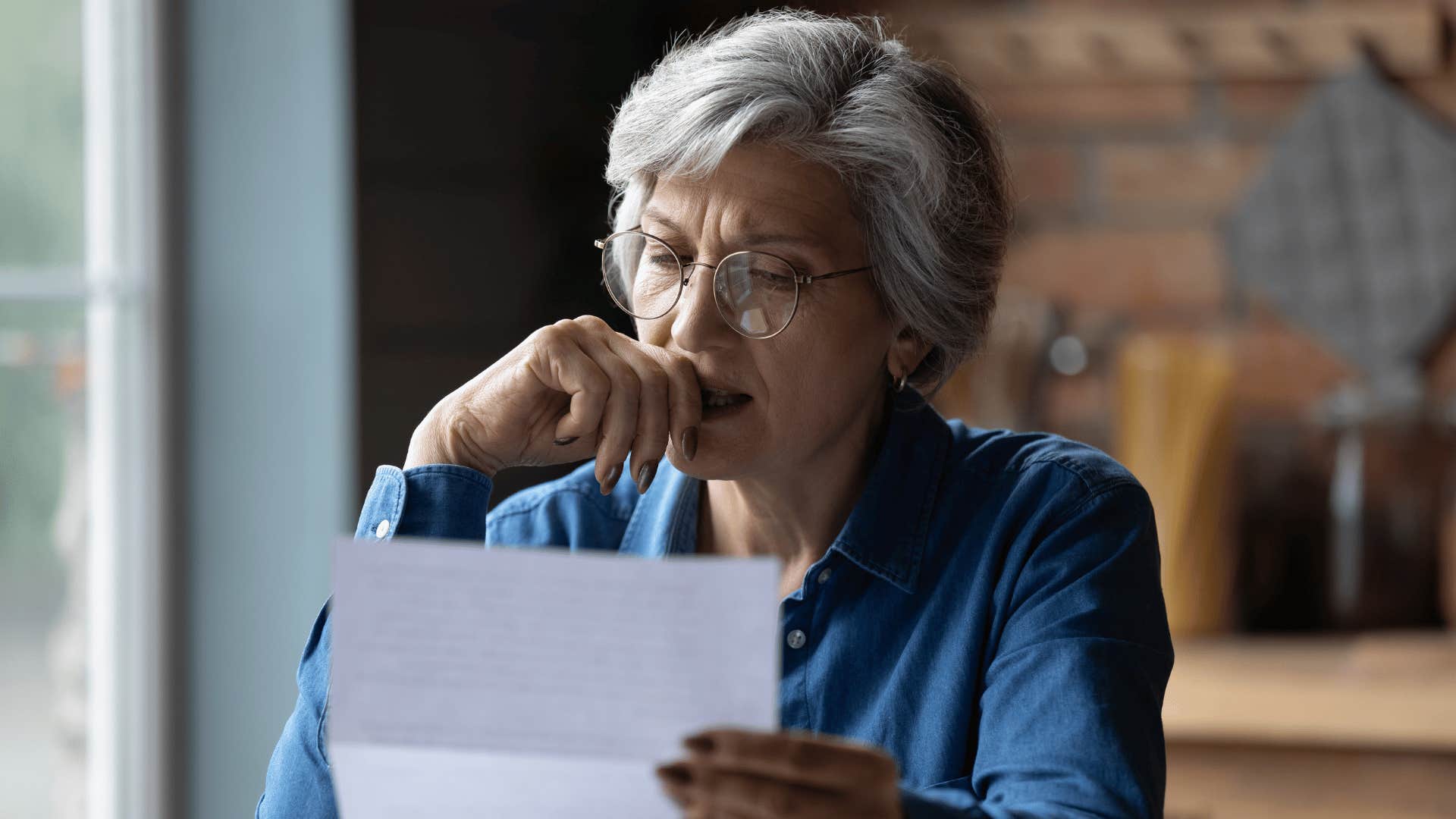 woman looking at paper stressed 