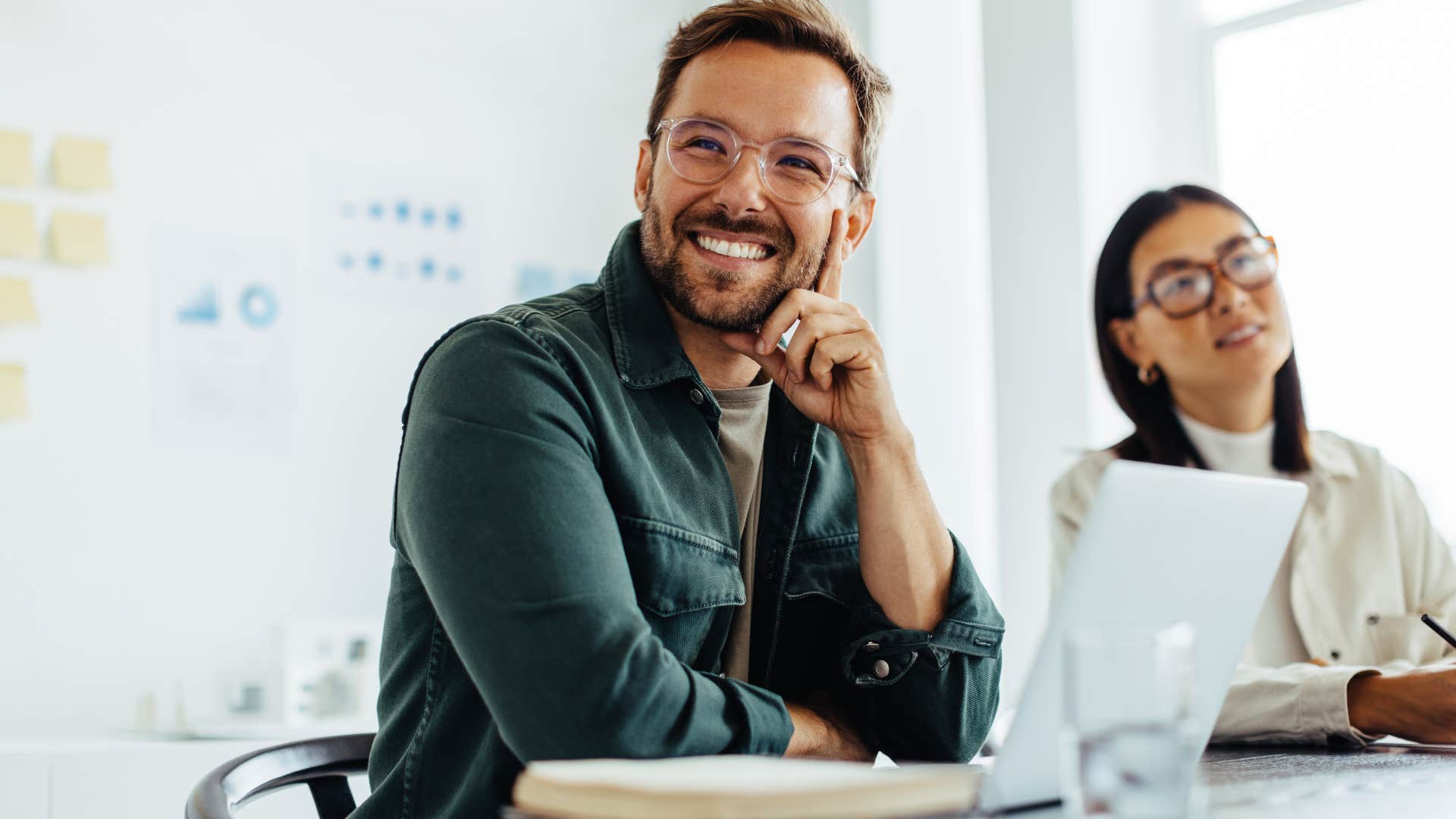 Man smiling at his work office desk.