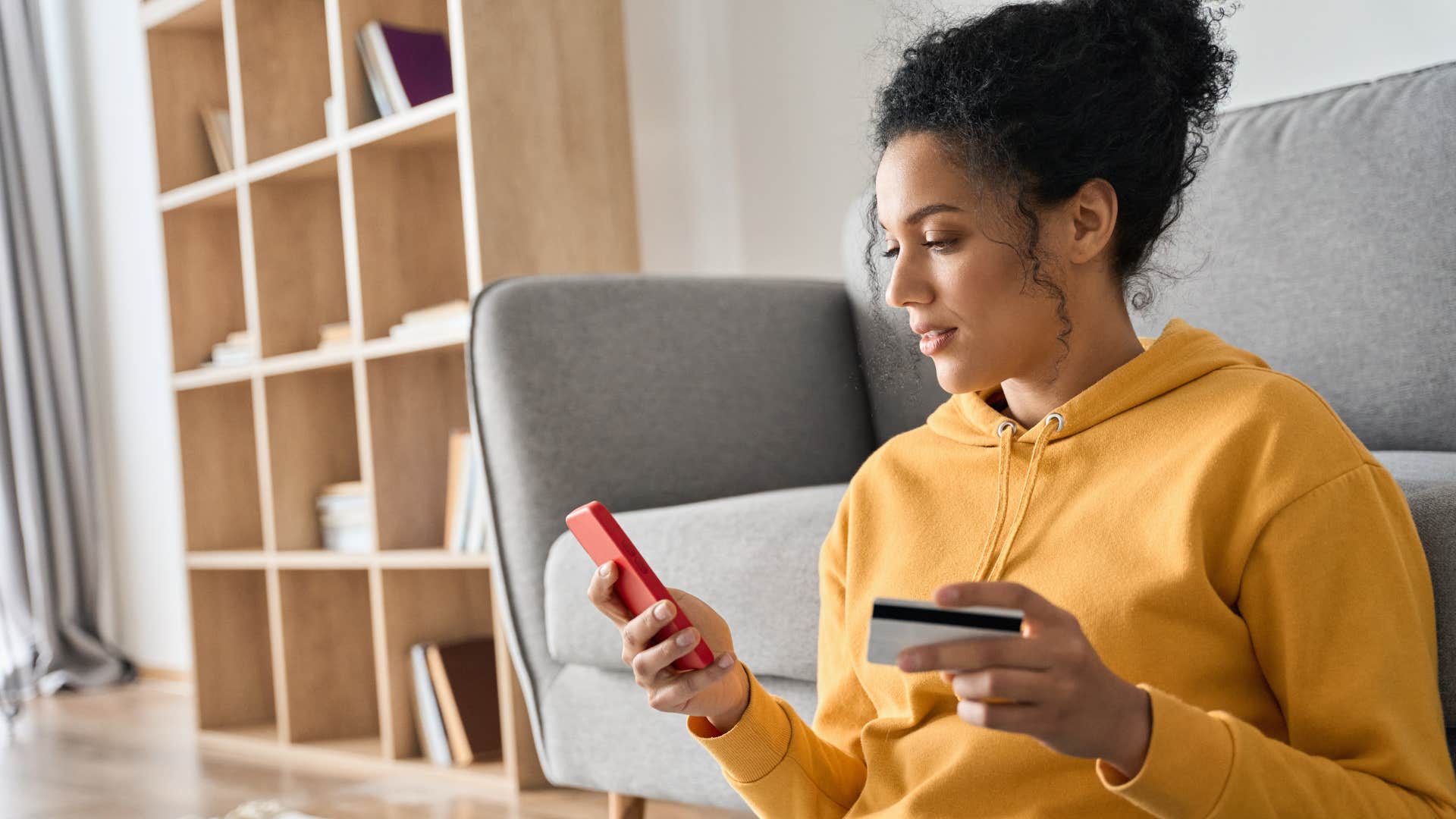 Woman smiling and typing on her phone.