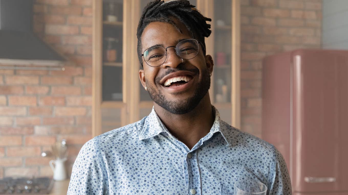 Man smiling at the camera in his kitchen.