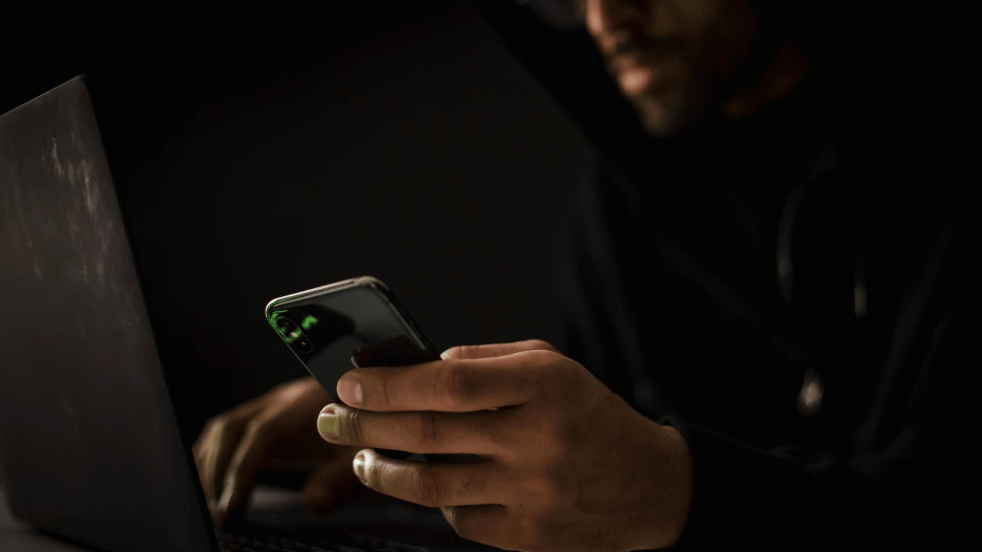 man on his phone in the dark