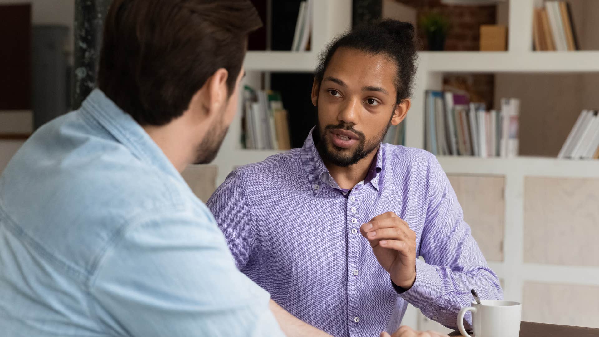 Man talking to his boss at work.