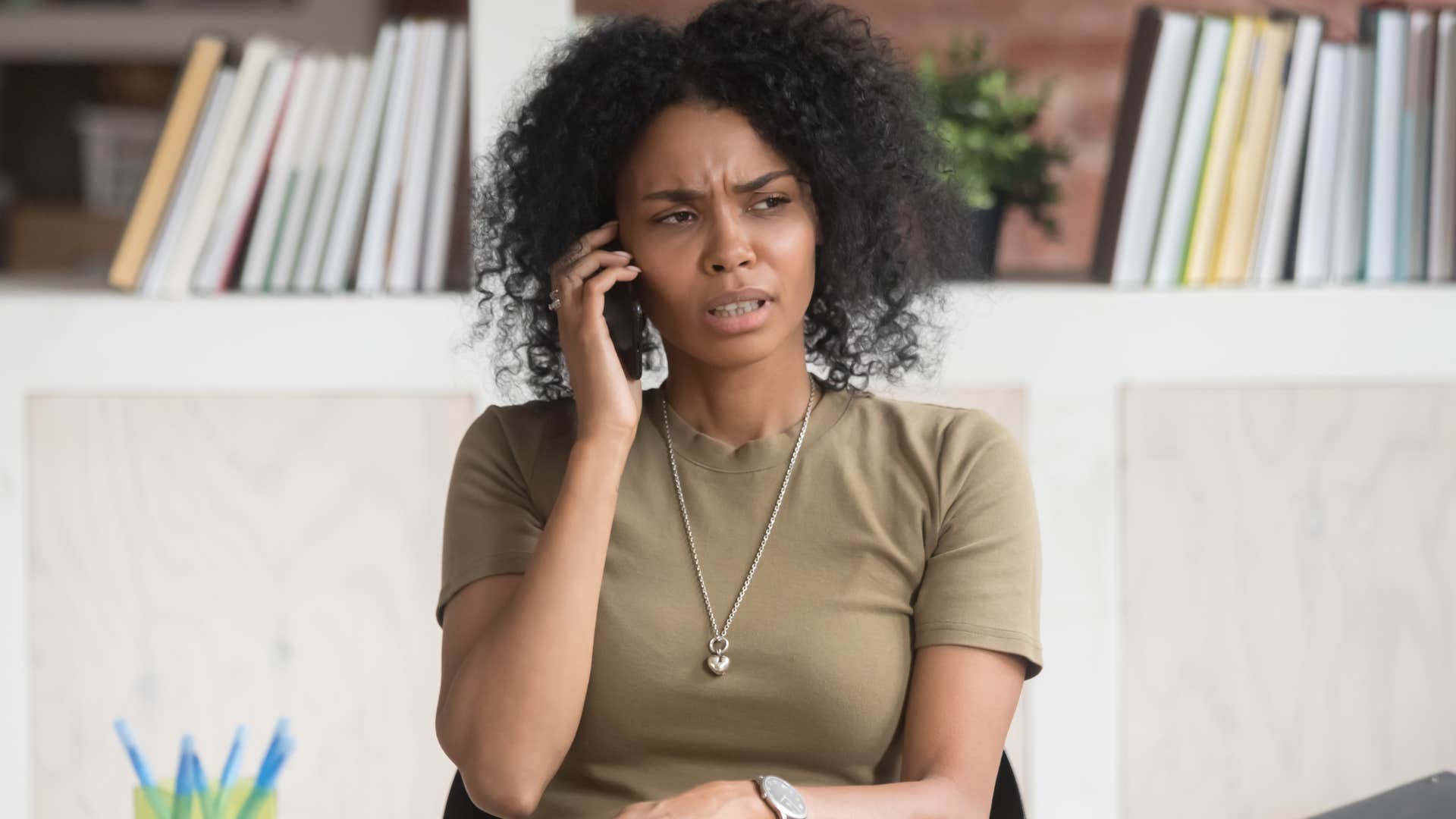 Woman looking upset talking on the phone.