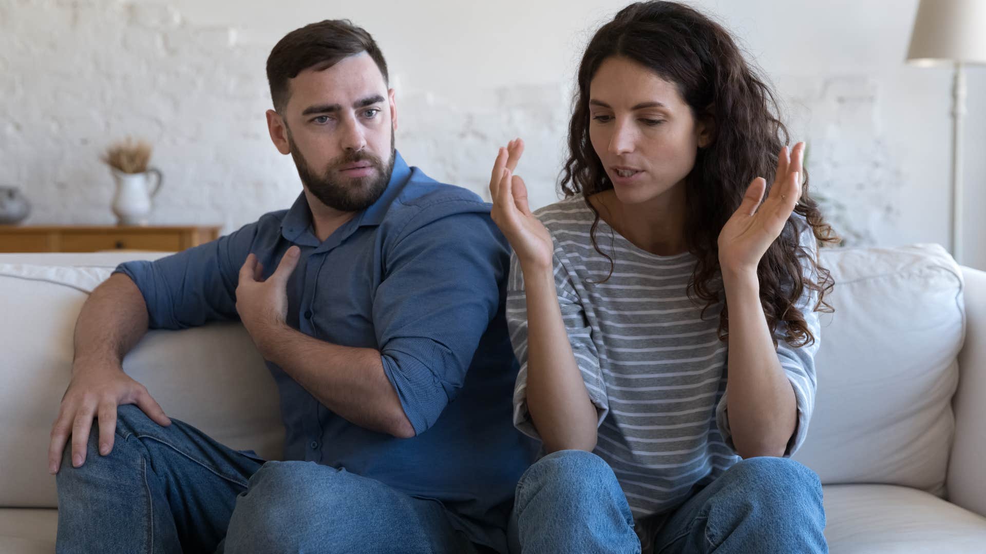 Couple arguing on the couch.