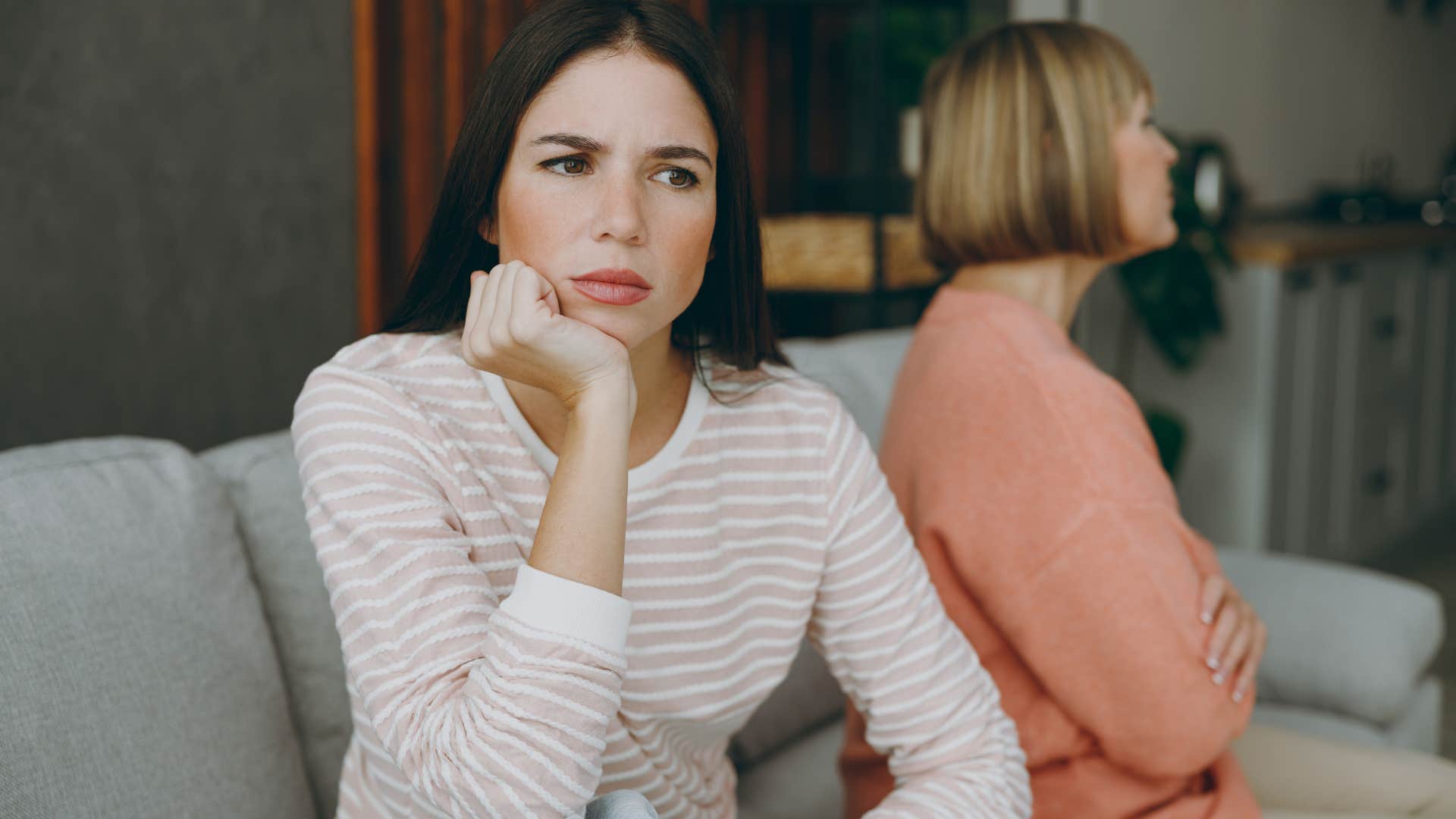 Adult daughter looking away from her upset mother. 