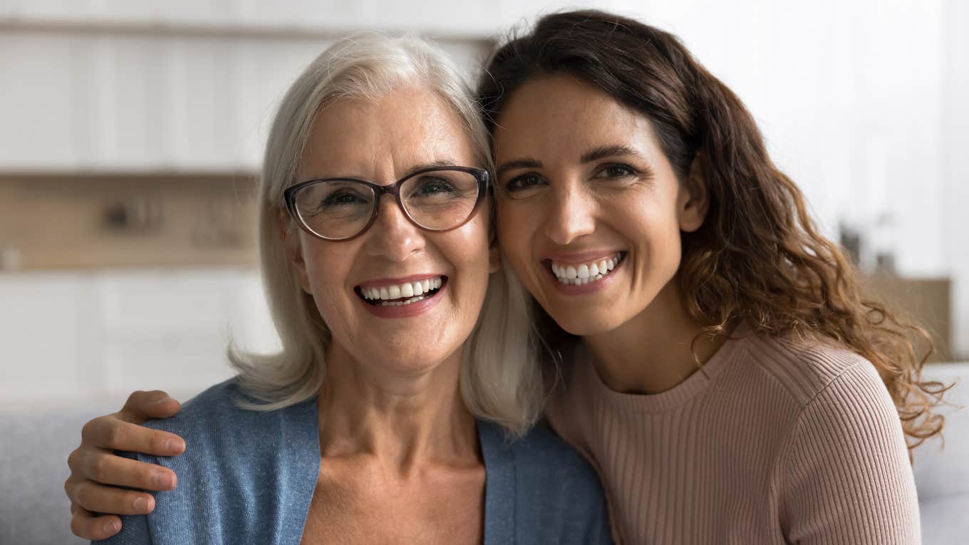 mother and daughter smiling at the camera