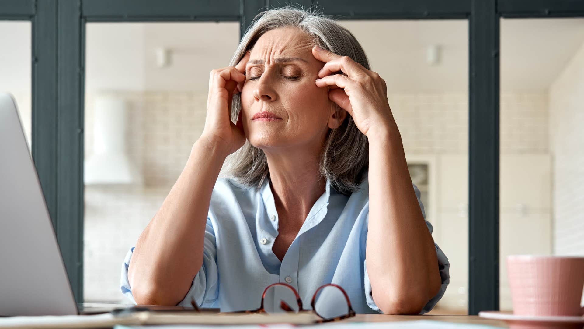 Older woman looking annoyed while talking on the phone