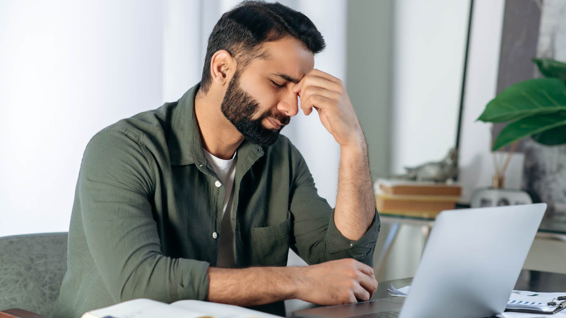 Man looking frustrated staring at his laptop