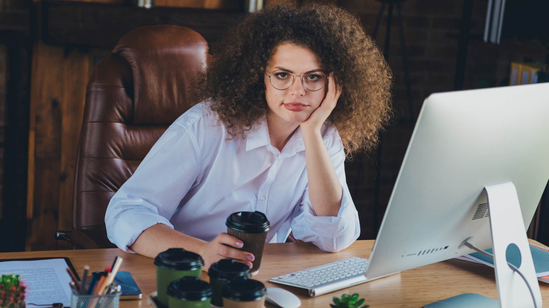 Woman looking bored sitting in front of her laptop