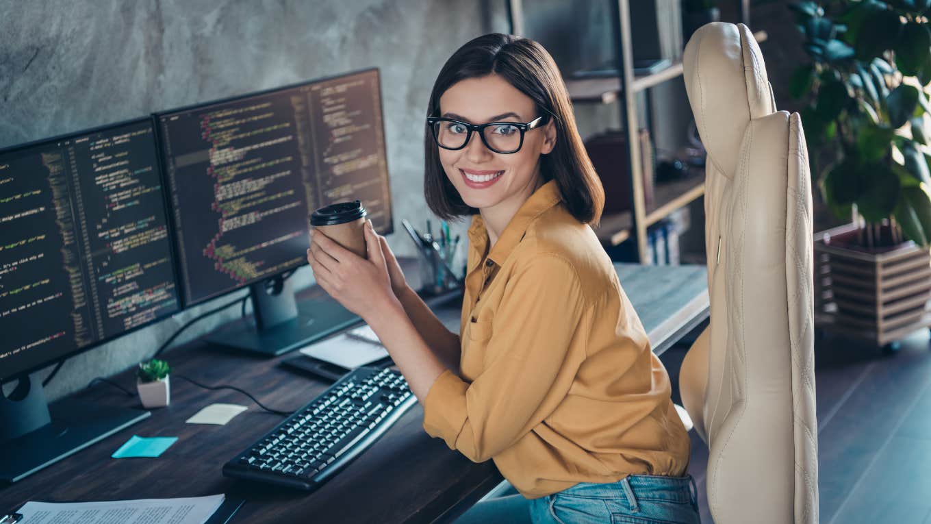 woman drinking coffee at work desk