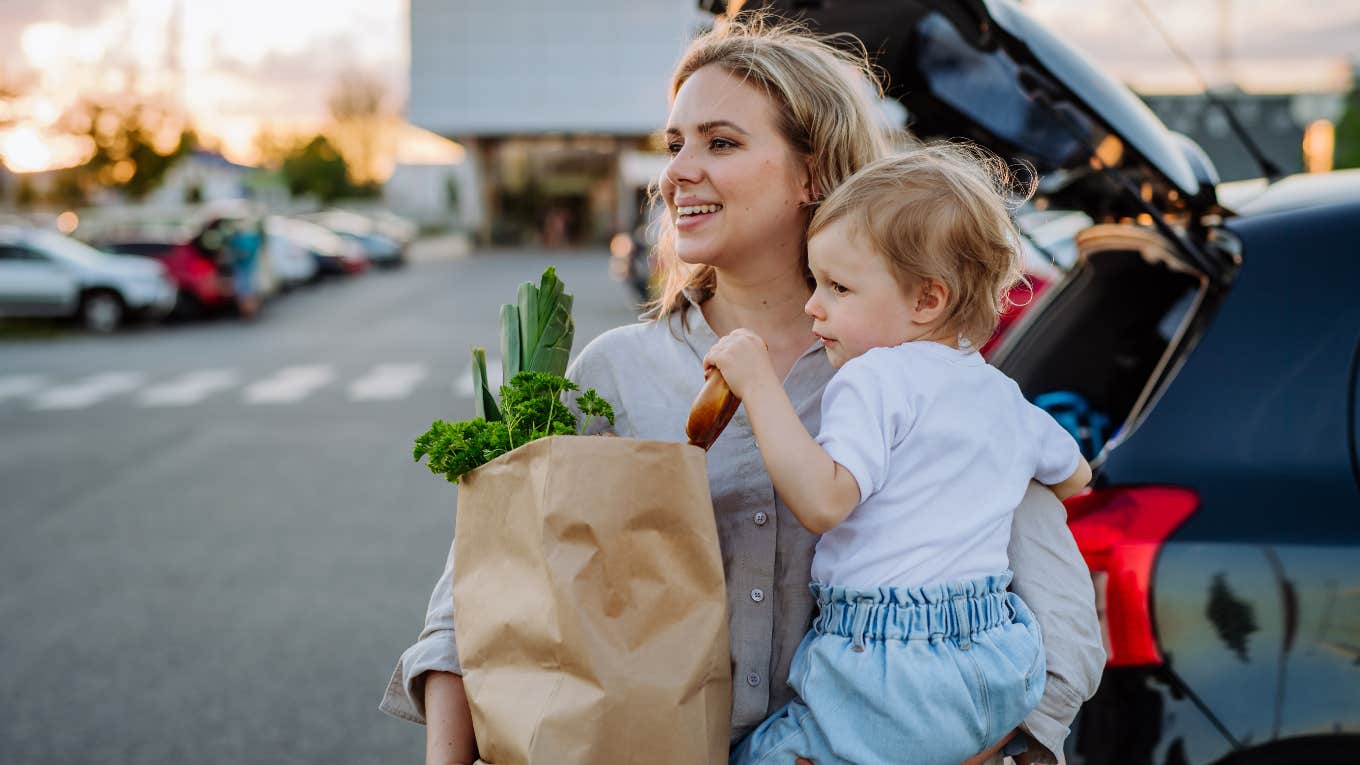 Single mom has her hands full with toddler and groceries