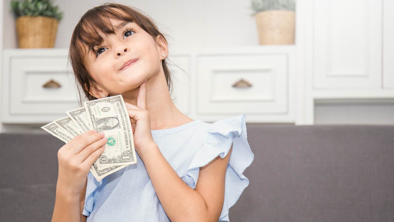 Little girl holding Christmas money