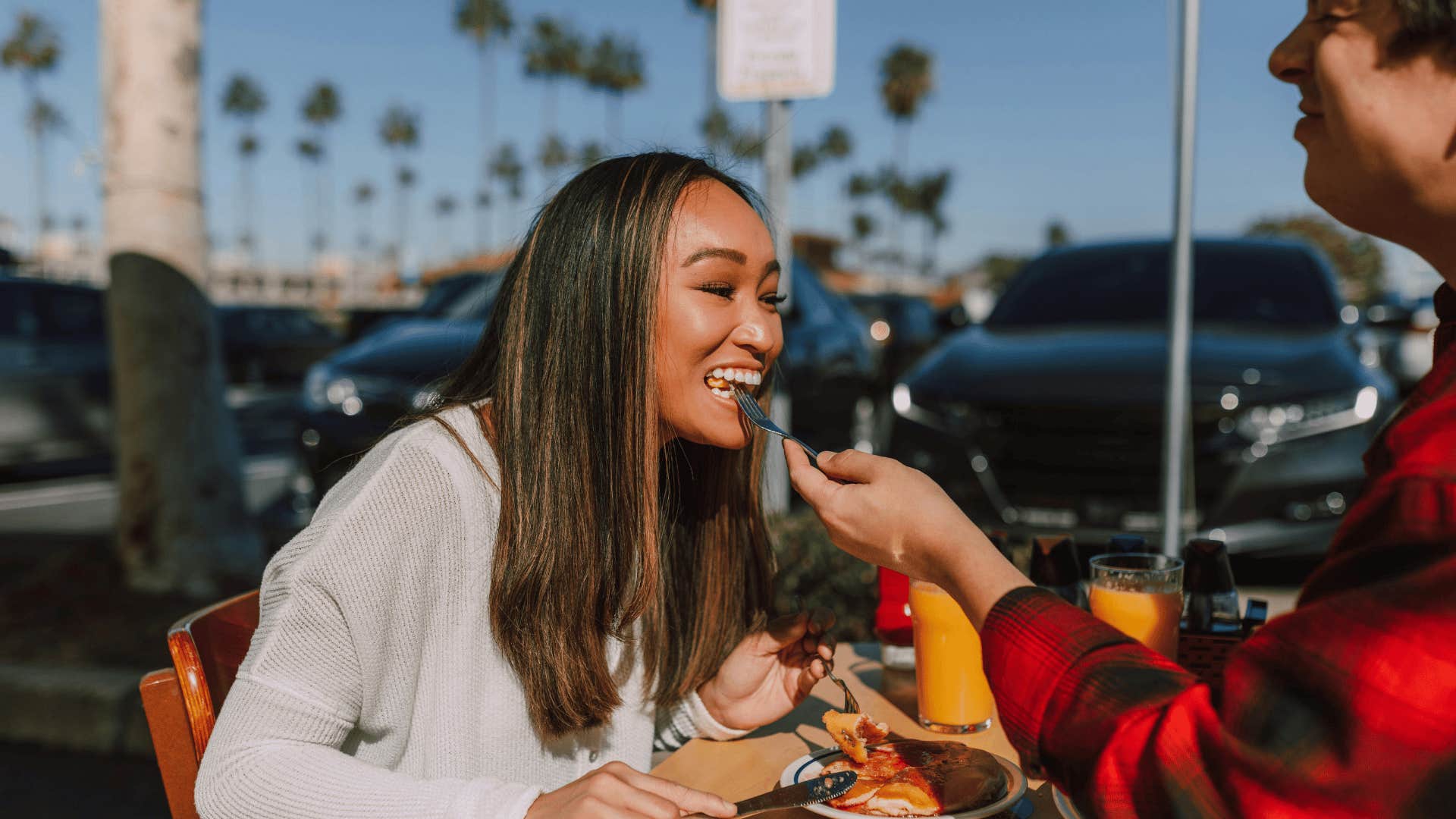 man feeding woman