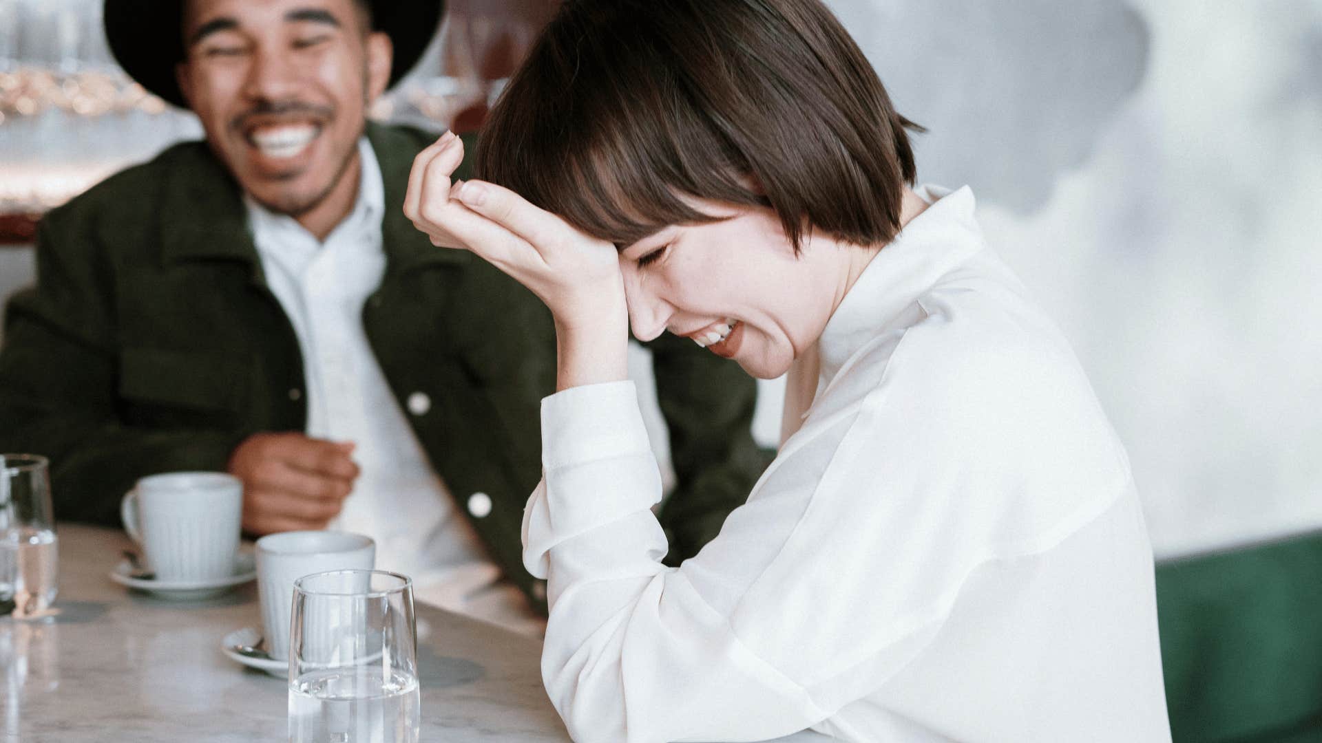 couple sitting down and laughing