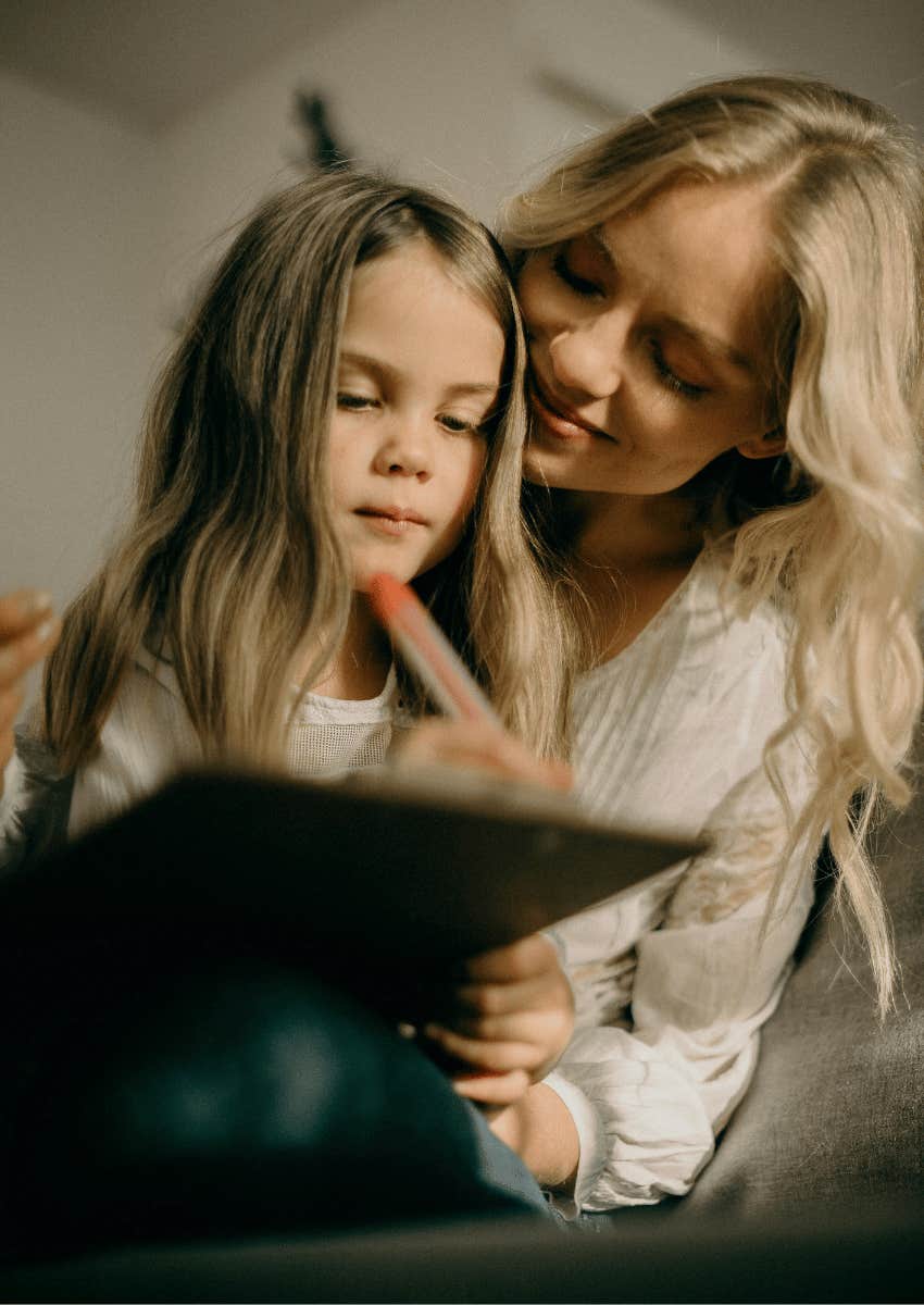 smiling mom and young girl drawing